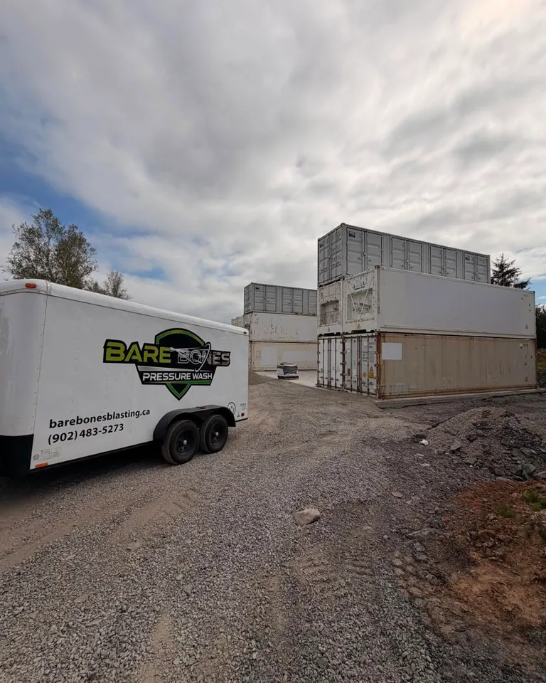 Bare Bones trailer set up beside industrial shipping containers