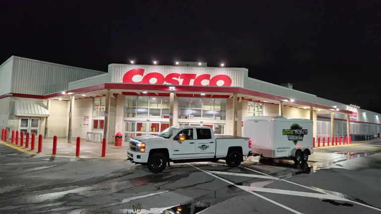 Bare Bones Pressure Wash truck and service trailer at a nighttime Costco cleaning job