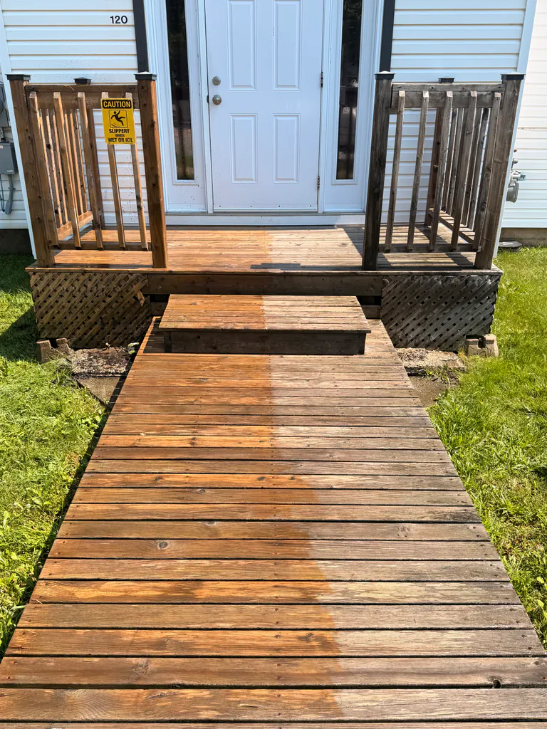 Wooden front walkway and steps partially cleaned to show the contrast between weathered and refreshed wood