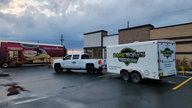 Bare Bones Pressure Wash truck and trailer beside the Tim Hortons mobile restaurant during renovations