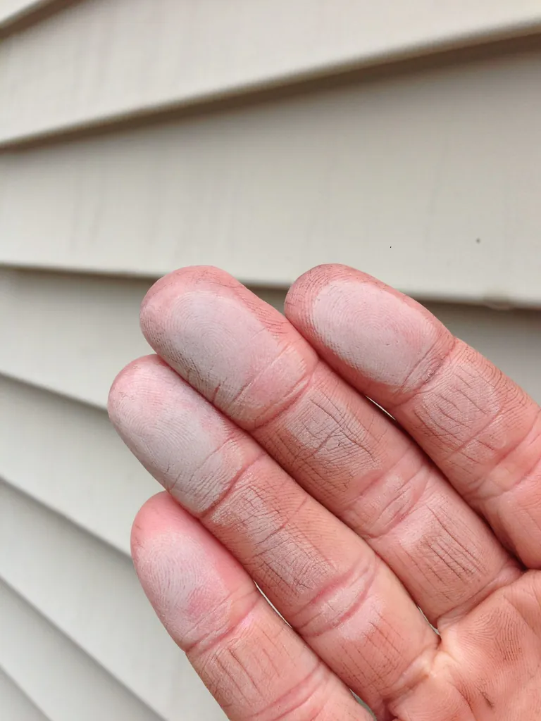 Chalky oxidation residue transferred from vinyl siding onto fingertips