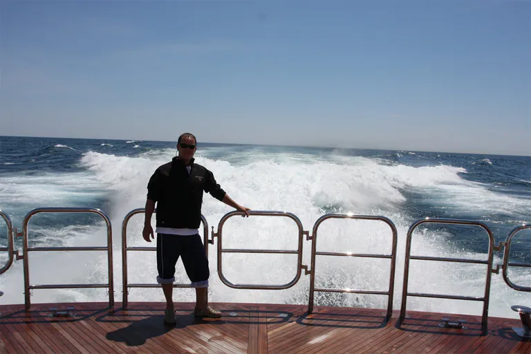 Peter cleaning a yacht deck during his time in the yachting industry