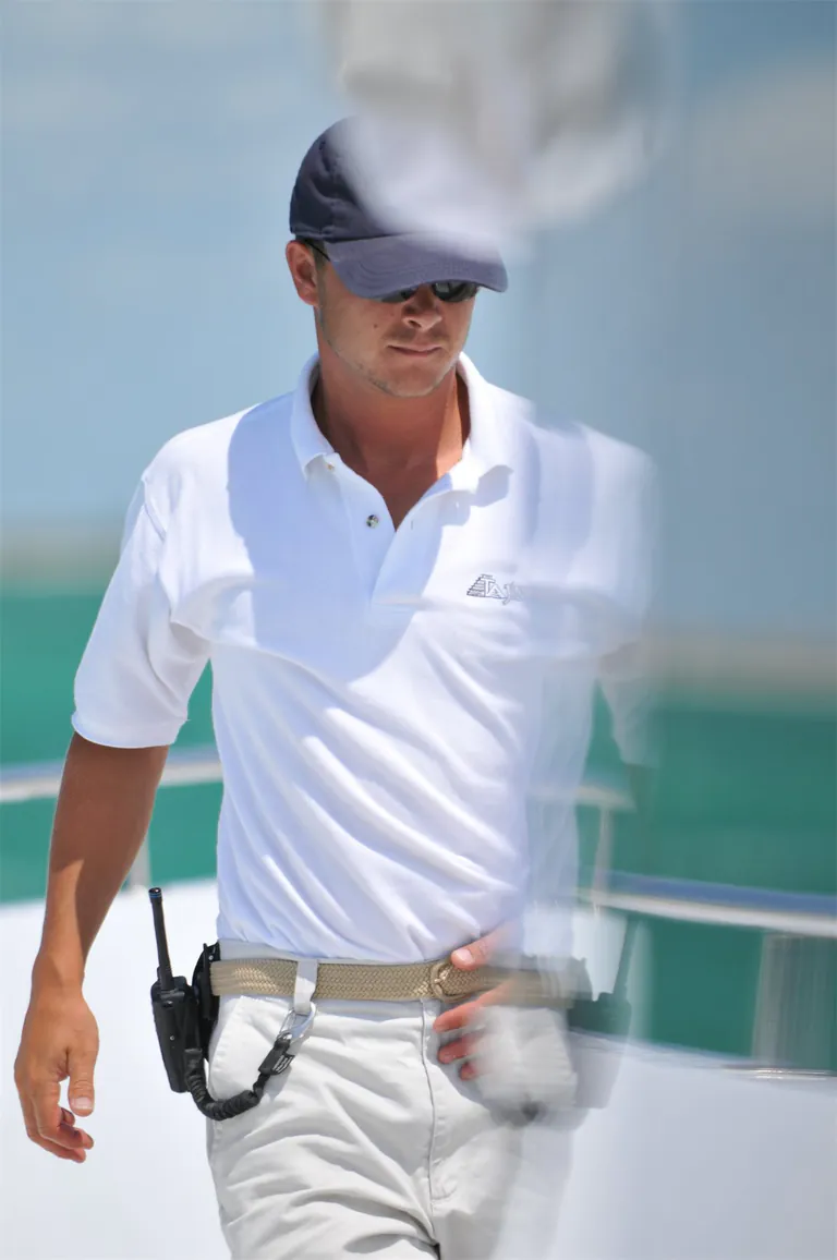Peter in yacht uniform beside the water